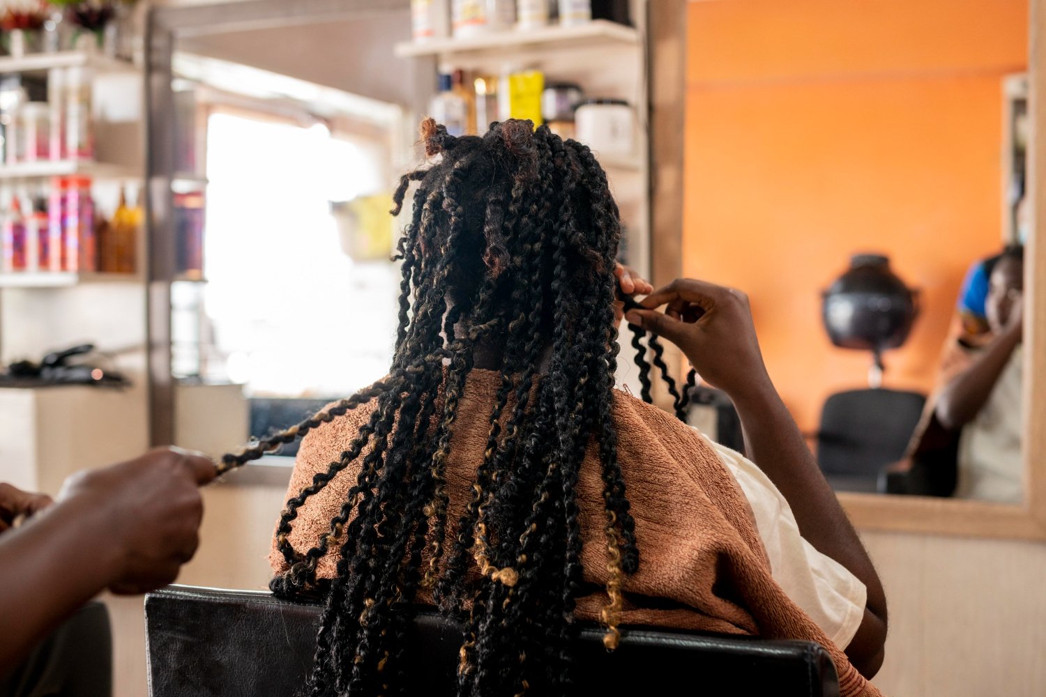 beautiful woman getting her braids done